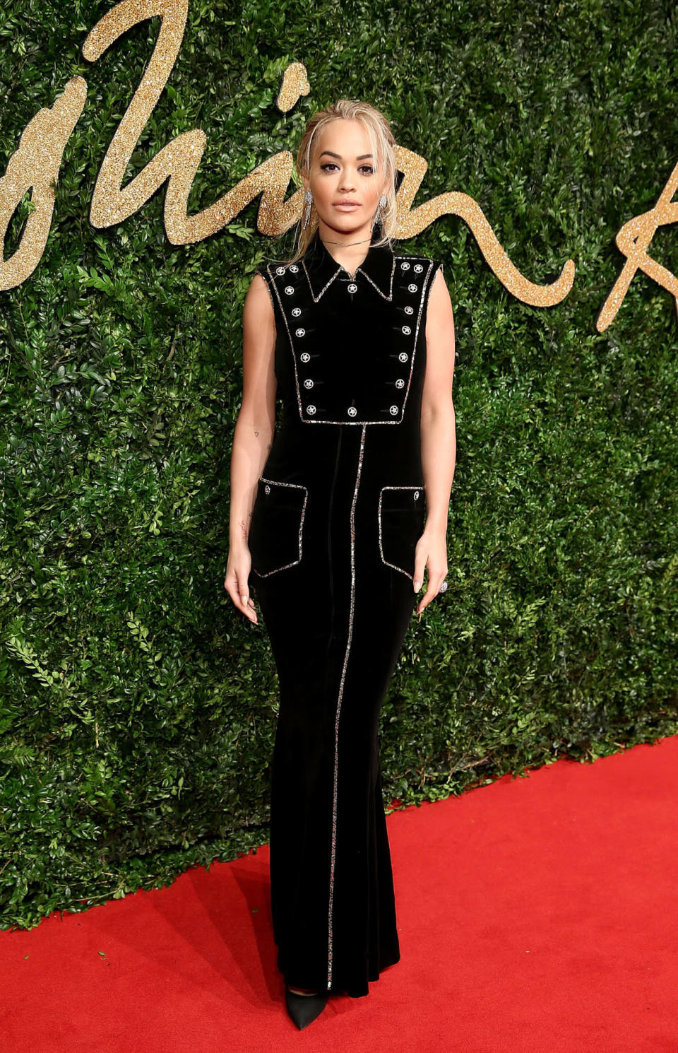 Rita Ora in a black collared gown with buttons and glitter detailing by Chanel. 