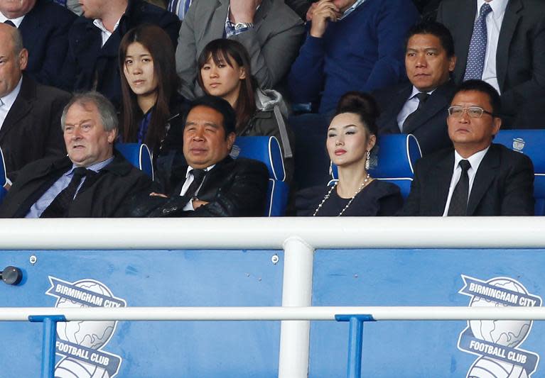 Carson Yeung (2nd left) watches Birmingham City play a Premier League game against Fulham at St. Andrews in Birmingham on May 15, 2011