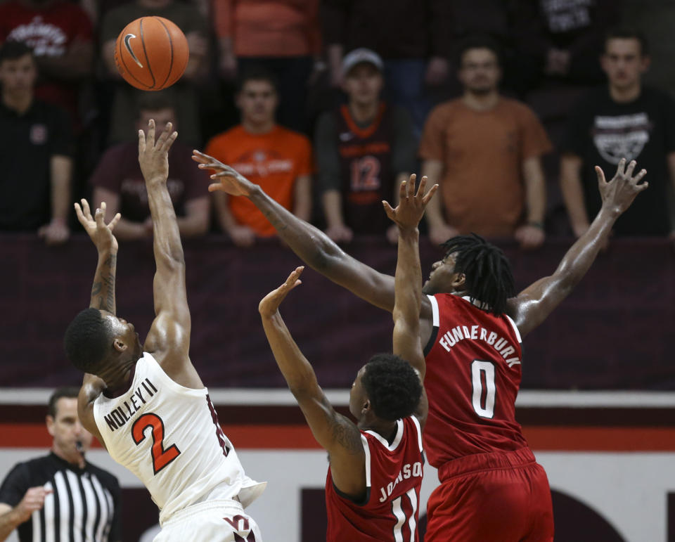 Virginia Tech's Landers Nolley II (2) shoots over North Carolina State's Markell Johnson (11) and D.J. Funderburk (0) in the first half of an NCAA college basketball game Saturday, Jan. 11, 2020, in Blacksburg, Va. (Matt Gentry/The Roanoke Times via AP)