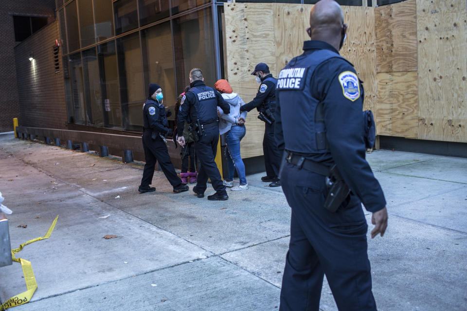 Police officers arrest an anti-Trump supporter during clashes with Trump supporters near Black Lives Matter Plaza following the "Million MAGA March" in Washington, DC. (Probal Rashid/LightRocket via Getty Images)