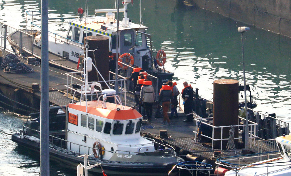 A group of people thought to be migrants are brought to shore at the Port of Dover