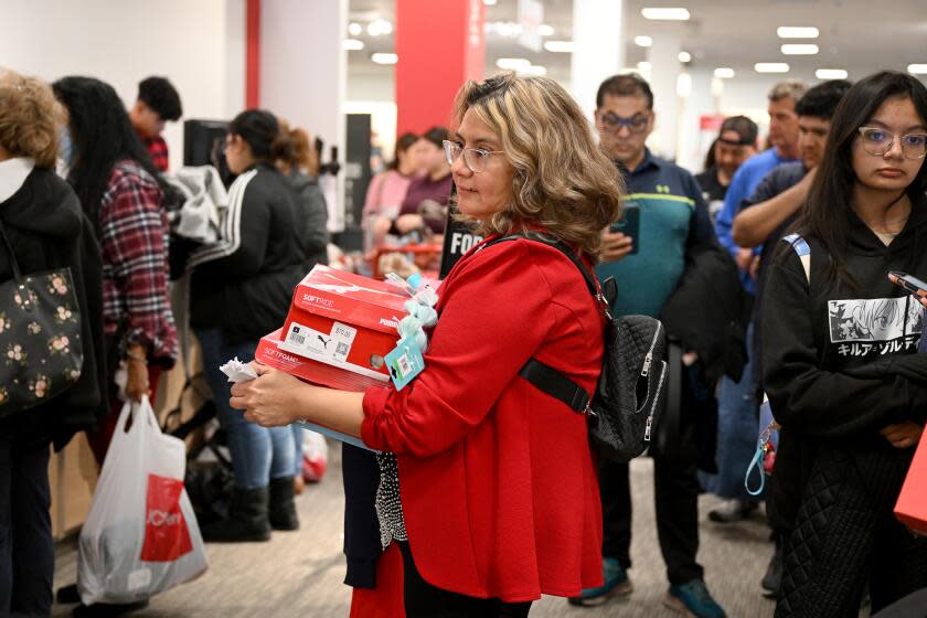 GLENDALE, CA - Nov. 24, 2023: Maria Panuco waits in line to check out while shopping JCPenny at the Glendale Galleria on Black Friday. (Michael Owen Baker / For The Times)