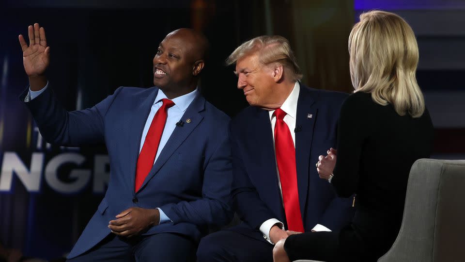 Sen. Tim Scott waves as he sits with former President Donald Trump during a Fox News town hall at the Greenville Convention Center on February 20, 2024 in Greenville, South Carolina. - Justin Sullivan/Getty Images