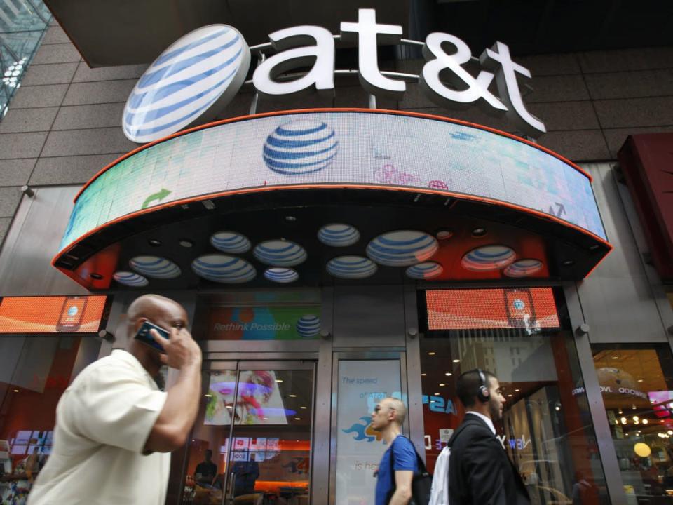 man talking on phone near AT&T store