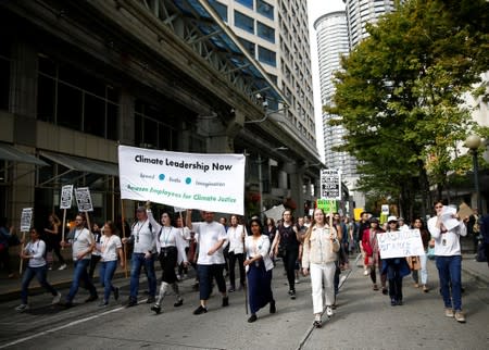 Amazon employees hold an "Amazon Employees for Climate Justice" sign during a Climate Strike march in Seattle,