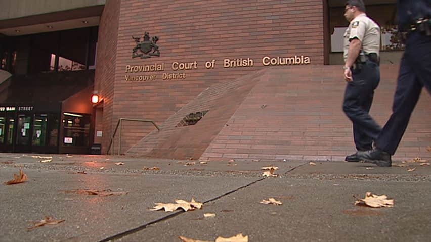 Sheriffs walk past Vancouver's provincial courthouse