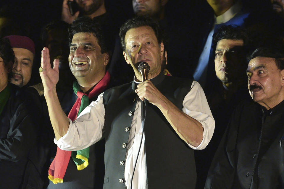 Pakistan's former Prime Minister Imran Khan, center, addresses during an anti-government rally in Islamabad, Pakistan, Saturday, Aug. 20, 2022. A Pakistani court on Tuesday, Aug. 23, 2022, was expected to initiate contempt proceedings against Khan for threatening a judge in a recent rally speech as pressure on the ousted premier intensified with police raiding the apartment of his close aide in the capital, and taking the associate away for interrogation. (AP Photo/W.K. Yousafzai)