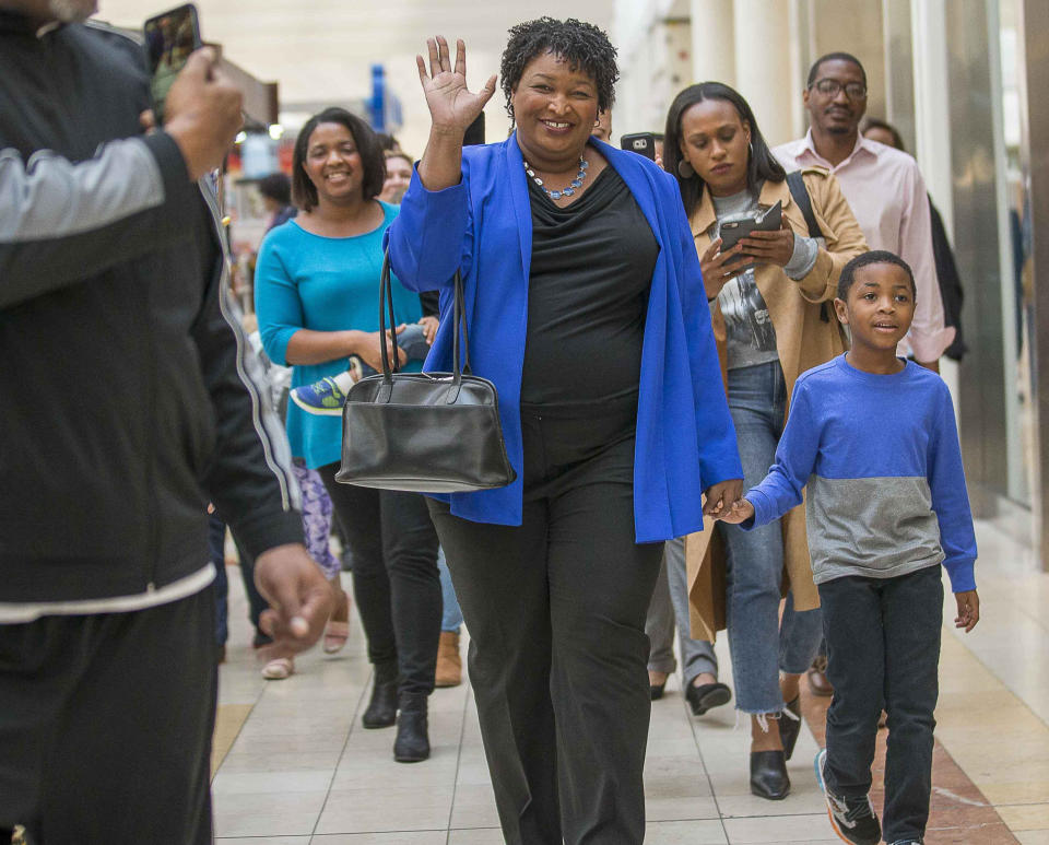 Gubernatorial candidate Stacey Abrams walks hand and hand with her nephew Cameron McLean[cq] as they prepare to vote early at The Gallery at South DeKalb Mall in Decatur, Ga., Monday, October 22, 2018. Today marks only 15 days left until Election Day on Tuesday, November 6. (Alyssa Pointer/Atlanta Journal-Constitution via AP)