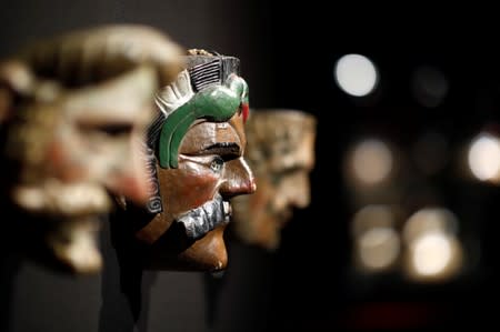 A spanish mask with moustache, one of pre-Columbian artefacts, is presented to the press at Drouot auction house in Paris