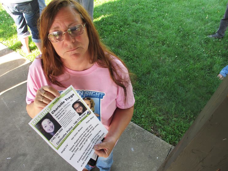 In this June 24, 2015, file photo, Yvonne Boggs holds a flier seeking information on her daughter, Charlotte Trego, who has been missing for more than a year, in Chillicothe, Ohio. The Investigation Discovery network says it will air its first-ever serialized drama later this spring. The six-part docu-series, 