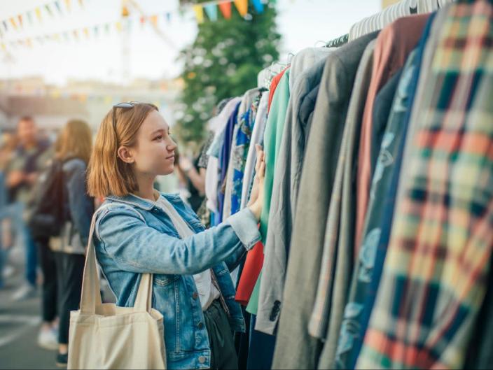 A young woman shops at a second-hand market (Getty Images)