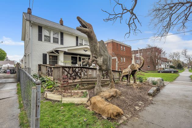 Animal statues, including a 12-foot dinosaur sculpture, tower over the front lawn of a Cleveland home. (Photo: Courtesy of Randee Pollarine | WindowStill)