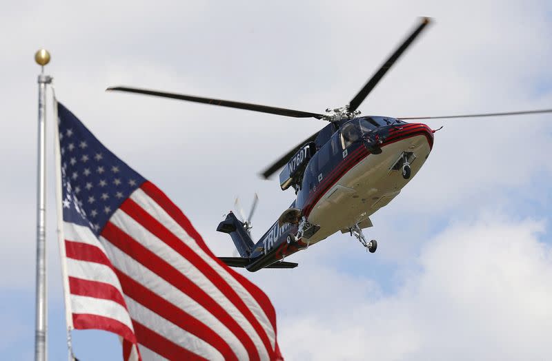 FILE PHOTO: U.S. Republican presidential candidate Donald Trump's helicopter lands in a field before his visit to the Iowa State Fair during a campaign stop in Des Moines