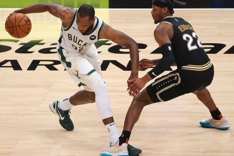 Khris Middleton ante Cam Reddish; Milwaukee le ganó a Atlanta y jugará la final de la NBA contra Phoenix