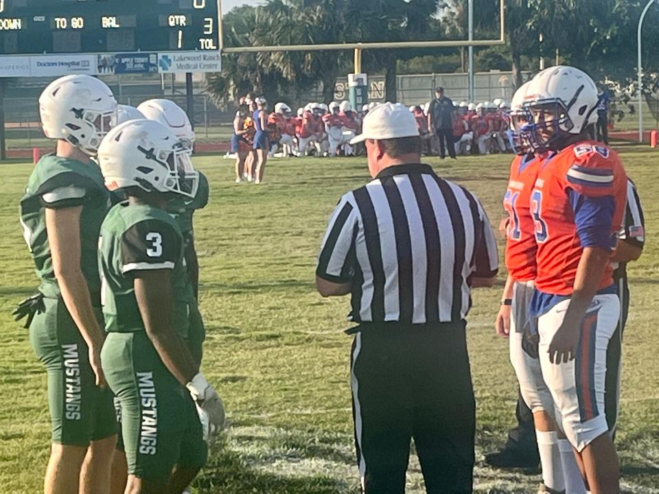 Captains meet in the center of the field for the coin toss prior to the Lakewood Ranch-Seminole Osceola Fundamental spring football game Thursday evening at the Mustangs field.