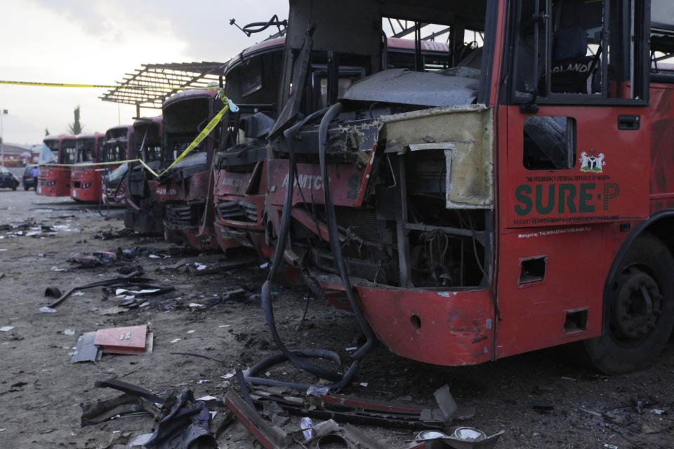 Damaged buses are seen at the scene of an explosion at a bus park in Abuja, Nigeria, Monday, April. 14, 2014. Suspected Islamic militants struck at the heart of Nigeria with a massive rush-hour explosion at a bus station Monday that killed 71, with the toll expected to rise in the deadliest attack yet on the nation’s capital. (AP Photo/ Sunday Alamba)