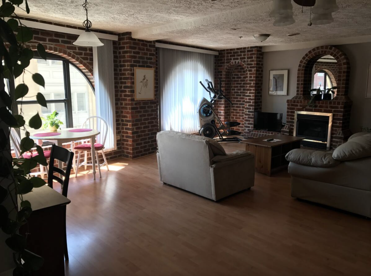 The Vault Downtown Loft living room with brick walls