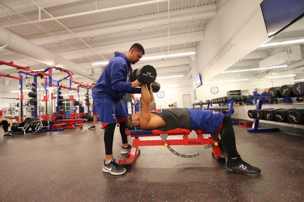 Former East High School and Colorado State University Pueblo baseball player Al Sandoval spots Texas Rangers player Rougned Odor during a training session. [Courtesy photo/Al Sandoval]