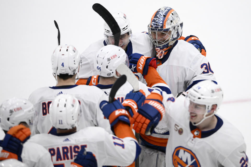 New York Islanders goaltender Ilya Sorokin celebrates with teammates after an NHL hockey game against the Washington Capitals, Wednesday, March 29, 2023, in Washington. The Islanders won 2-1 in a shootout. (AP Photo/Nick Wass)