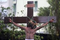 A performer takes part in a re-enactment of the death of Jesus Christ, on Good Friday in Lagos April 18, 2014.