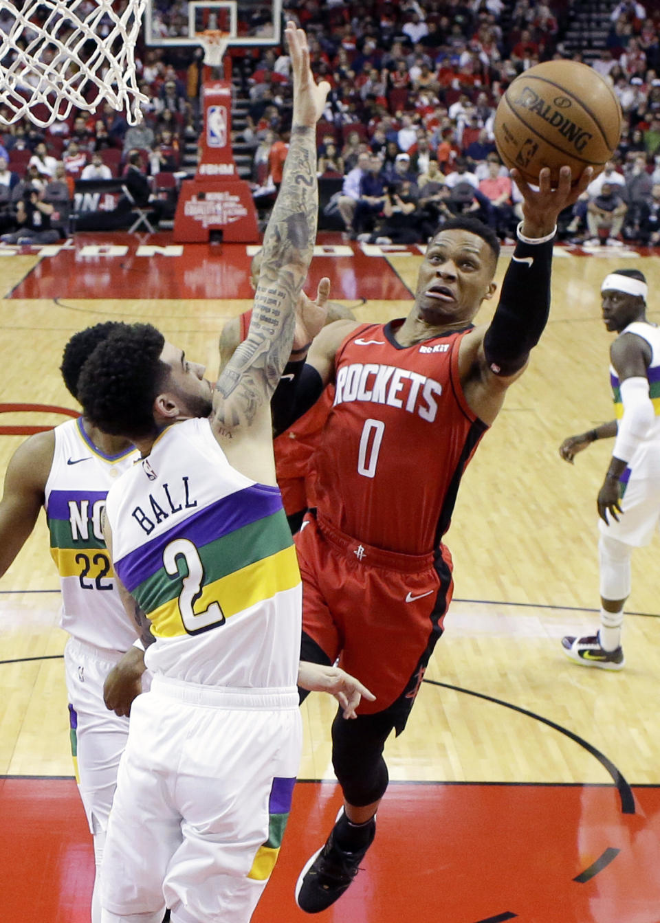 Houston Rockets guard Russell Westbrook (0) drives to the basket as New Orleans Pelicans guard Lonzo Ball (2) defends during the first half of an NBA basketball game, Sunday, Feb. 2, 2020, in Houston. (AP Photo/Eric Christian Smith)