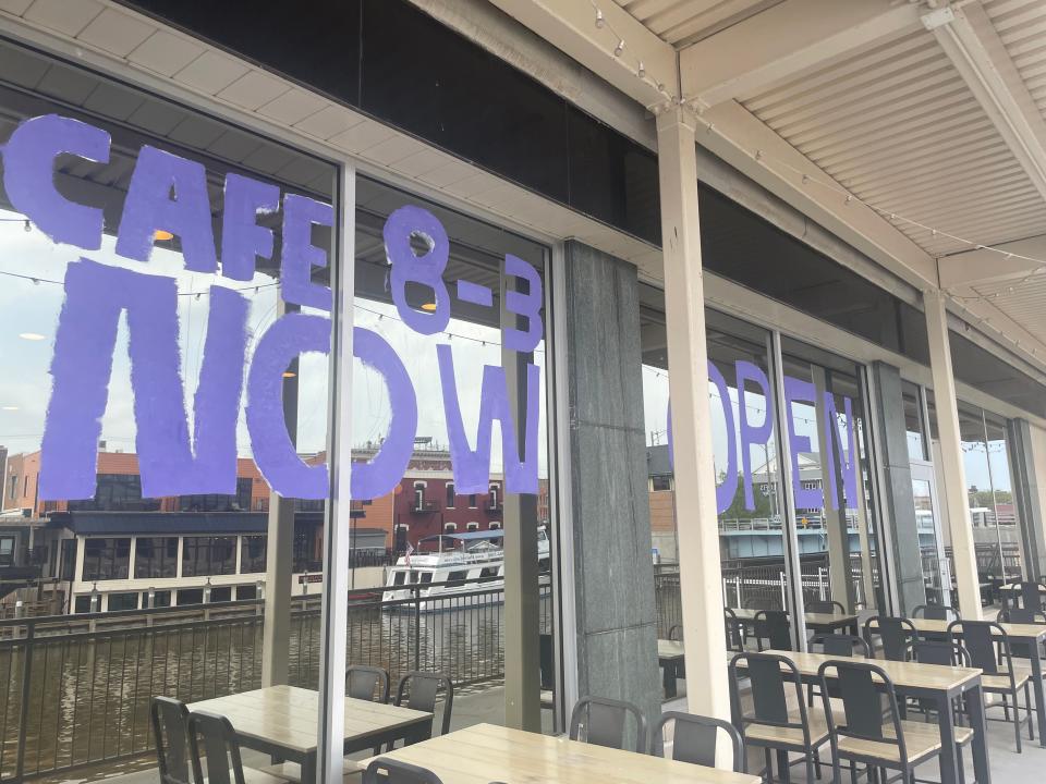 The windows of CitySide Cafe painted to say "Now Open" on May 16, 2024.