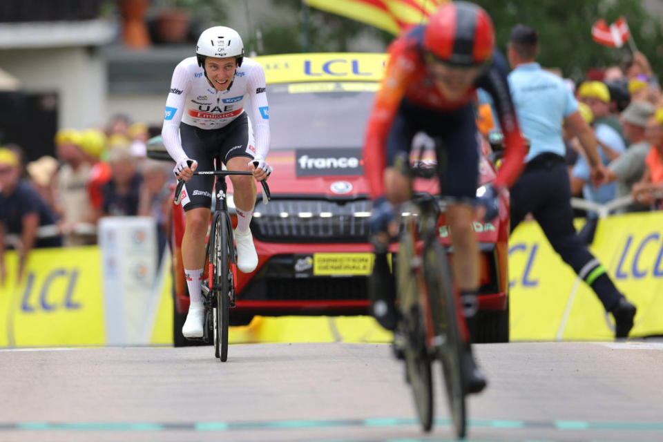 UAE Team Emirates' Slovenian rider Tadej Pogacar (L) and INEOS - Grenadiers' Spanish rider Carlos Rodriguez Cano (R) cycle to the finish line during the 16th stage of the 110th edition of the Tour de France cycling race, 22 km individual time trial between Passy and Combloux, in the French Alps, on July 18, 2023. (Photo by Thomas SAMSON / AFP)