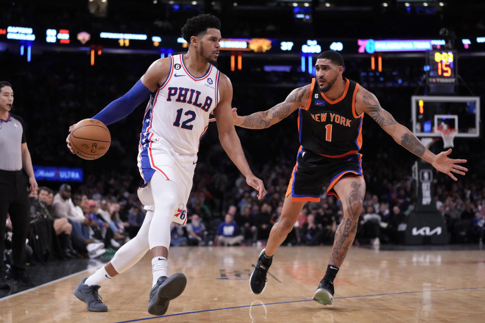 Philadelphia 76ers forward Tobias Harris (12) drives around New York Knicks forward Obi Toppin (1) during the first half of an NBA basketball game, Sunday, Feb. 5, 2023, in New York. (AP Photo/John Minchillo)