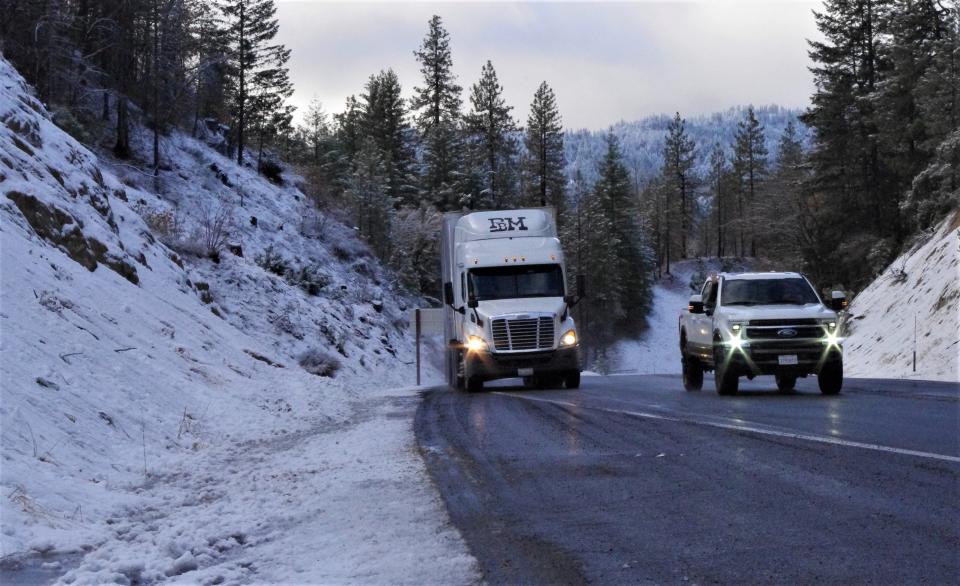 Vehicles make their way over Buckhorn Summit on Highway 299 after fresh snow fell on the mountains west of Redding on Thursday morning.