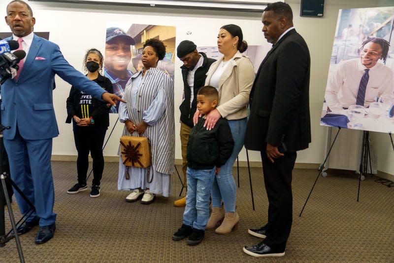 Lawyer Carl Douglas, far left, holds a news conference to announce filing a $50 million in damages claim against the city of Los Angeles over the death of Keenan Anderson, seen pictured on posters, in Los Angeles Friday, Jan. 20, 2023. 

