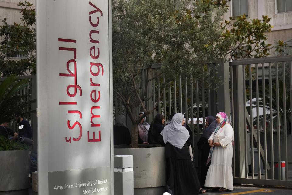 CORRECTS DAY TO TUESDAY WHEN INJURED Families of victims who were injured on Tuesday by their exploding handheld pagers, wait at the emergency entrance of the American University hospital, in Beirut, Lebanon, Wednesday, Sept. 18, 2024. (AP Photo/Hussein Malla)