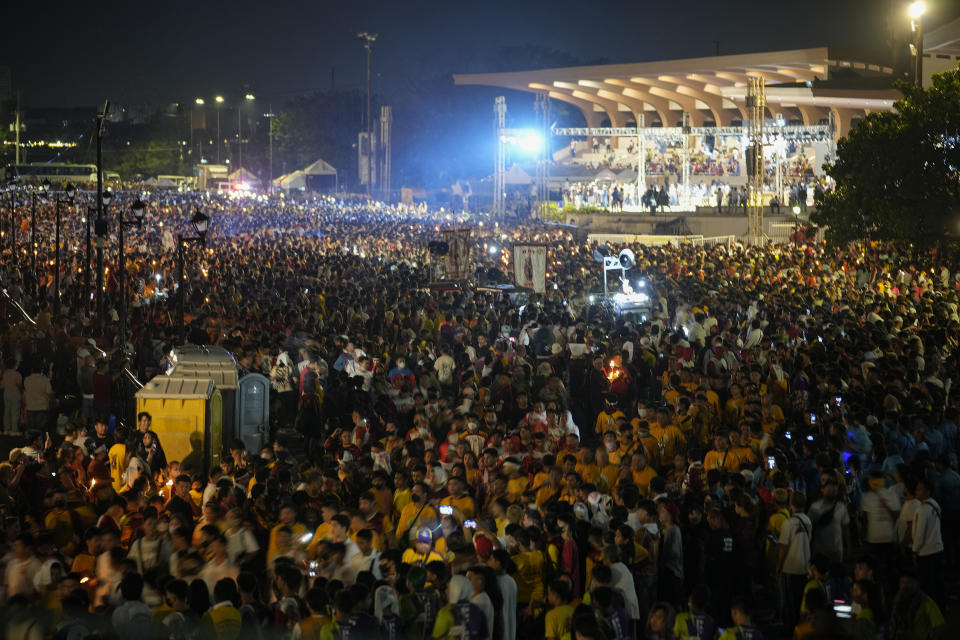 Devotees gather at the start of the "Walk of Faith" procession as part of celebrations for the feast day of the Black Nazarene, a centuries-old charred statue of Jesus Christ, on Sunday, Jan. 8, 2023, in Manila, Philippines. The annual Black Nazarene feast day which will be held on Jan. 9 draws massive numbers of devotees who pray for the sick and a better life in this predominantly Roman Catholic nation. (AP Photo/Aaron Favila)