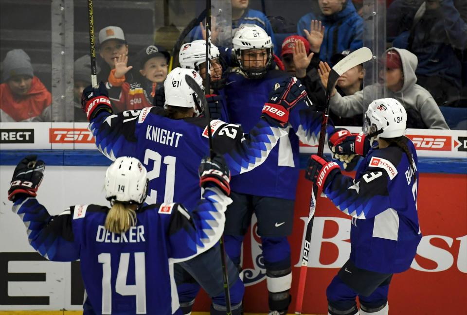 Team of USA celebrate a goal during the 2019 IIHF Women's World Championships preliminary match between USA and Canada in Espoo, Finland, Saturday April 6, 2019. (Antti Aimo-Koivisto/Lehtikuva via AP)