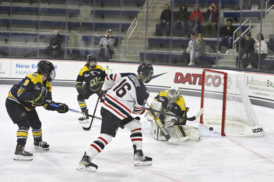 UConn's Kyla Josifovic (16 ) shoots on goal against Merrimack during an NCAA college hockey game at the Toscano Family Ice Forum, Friday, Jan. 13, 2023, in Storrs, Conn. (AP Photo/Jessica Hill)