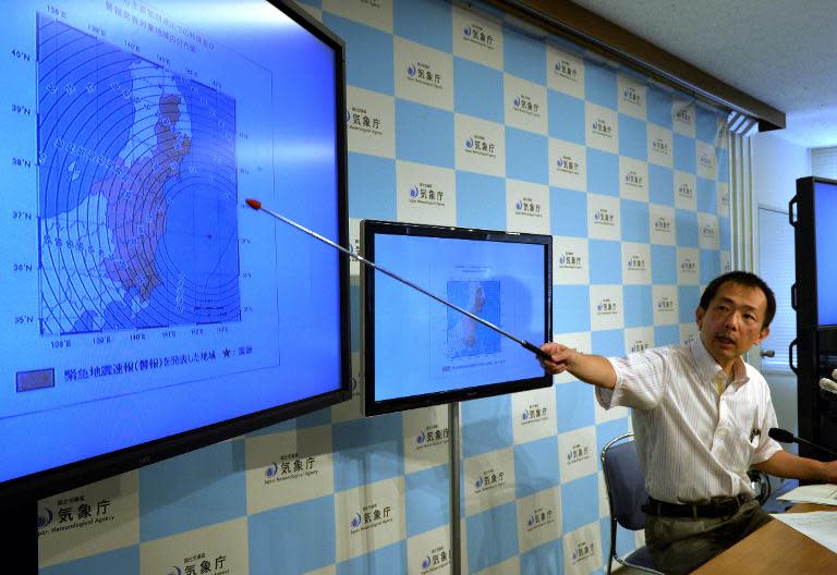 Japan Meteorological Agency officer Yasuhiro Yoshida speaks at a press conference in Tokyo on July 12, 2014, after a strong 6.8 magnitude earthquake struck off the country's Pacific coast