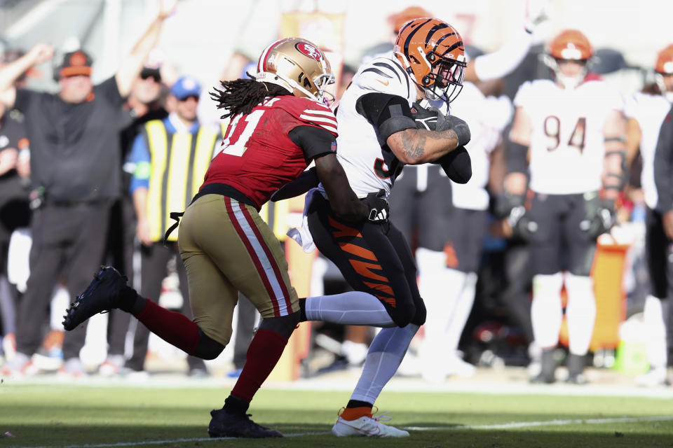 Cincinnati Bengals linebacker Logan Wilson, right, returns an interception in front of San Francisco 49ers wide receiver Brandon Aiyuk during the second half of an NFL football game in Santa Clara, Calif., Sunday, Oct. 29, 2023. (AP Photo/Jed Jacobsohn)