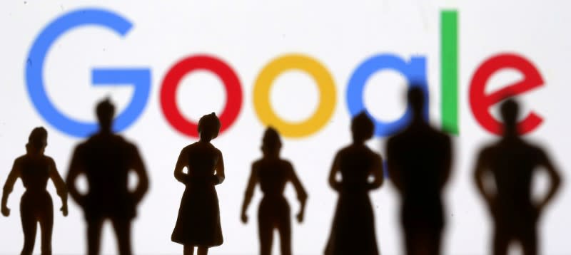 FILE PHOTO: Small toy figures are seen in front of Google logo in this illustration picture