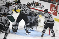 Los Angeles Kings goalie Jonathan Quick, center, looks down after allowing a goal by Minnesota Wild defenseman Mathew Dumba, back, during the first period of an NHL hockey game in Los Angeles, Saturday, Jan. 16, 2021. (AP Photo/Kelvin Kuo)