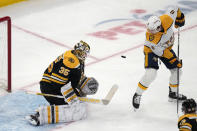 Nashville Predators center Cody Glass (8) tries to tip the puck on a shot while Boston Bruins goaltender Linus Ullmark (35) drops to make a save during the first period of an NHL hockey game Tuesday, March 28, 2023, in Boston. (AP Photo/Charles Krupa)