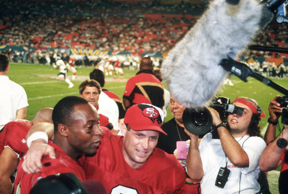 Victory over the San Diego Chargers in hand, San Francisco quarterback Steve Young celebrates with Jerry Rice on the sidelines late in the fourth quarter of Super Bowl XXIX on Jan. 29, 1995<span class="copyright">Focus on Sport/Getty Images</span>
