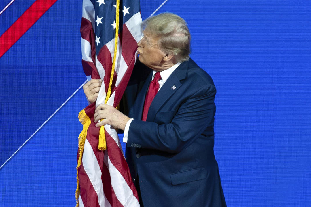 Donald Trump kisses the American flag.