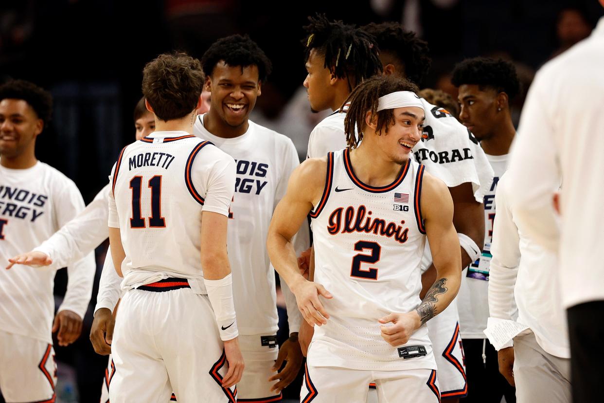 Members of the Illinois Fighting Illini celebrate their victory against the Nebraska Cornhuskers after the game at Target Center in the Semifinals of the Big Ten Tournament on Saturday in Minneapolis. The Fighting Illini defeated the Cornhuskers 98-87.