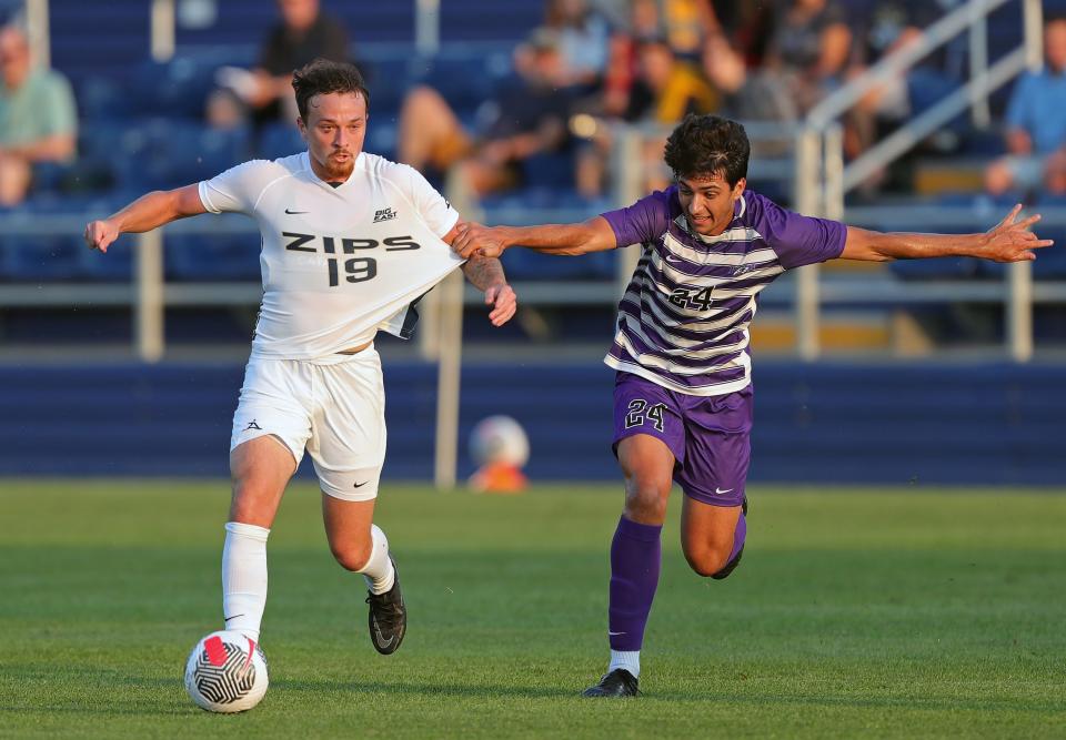 Akron midfielder Dyson Clapier, left, moves across the field against Niagara defender Alberto Sanchez Cervera on Aug. 24 in Akron.