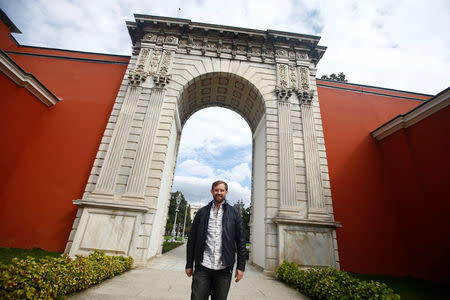 Naz Osmanoglu, a British comedian and member of Turkey's former ruling family, poses at the entrance of the Ottoman-era Dolmabahce Palace in Istanbul, Turkey, October 19, 2016. REUTERS/Osman Orsal