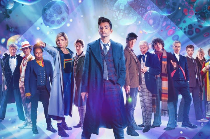 The Doctors all stand in a line on a Doctor Who promotional poster.