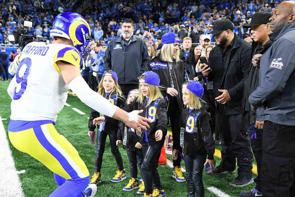 <p>Steven King/Icon Sportswire via Getty</p> Matthew Stafford hugs his four kids on the sidelines