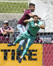 Los Angeles FC goalkeeper John McCarthy, front, dives under Colorado Rapids forward Diego Rubio to block a shot in the first half of an MLS soccer match Saturday, May 14, 2022, in Commerce City, Colo. (AP Photo/David Zalubowski)