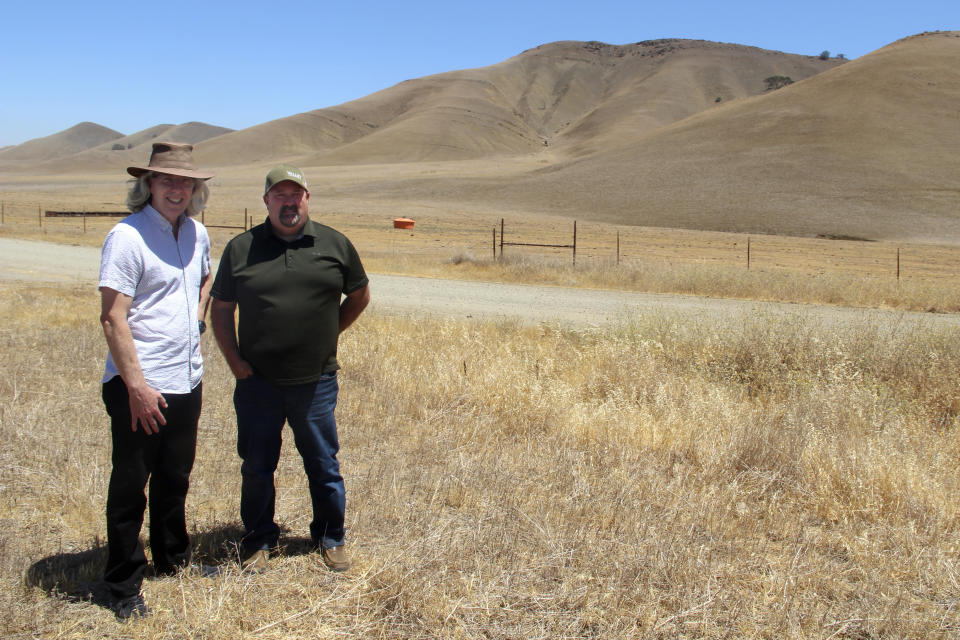 Jerry Brown, left, and Kevin Spesert stand at what would be the bottom of the Sites Reservoir in Sites, Calif., on Friday, July 23, 2021. Brown is the executive director of the Sites Project Authority and Spesert is the authority's public affairs and real estate manager. The project would be used to store water during wet years for use during droughts. The reservoir would be large enough to supply water for 1.5 million households each for one year. (AP Photo/Adam Beam)