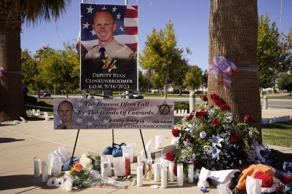 A shrine to honor deputy Ryan Clinkunbroomer is placed outside of the Palmdale Sheriff's Station during a press to announce an arrest in the ambush killing of the Los Angeles County sheriff's deputy Monday, Sept. 18, 2023, in Palmdale, Calif. Clinkunbroomer was shot and killed while sitting in his patrol car Saturday evening in Palmdale. (AP Photo/Marcio Jose Sanchez)