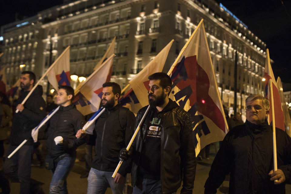 Members of the Communist-affiliated PAME labor union hold flags during a protest in central Athens on Tuesday, Dec. 18, 2018, as the Greek lawmakers are debating the heavily-indebted country's draft budget for 2019, the first since Greece exited an eight-year bailout program.(AP Photo/Petros Giannakouris)